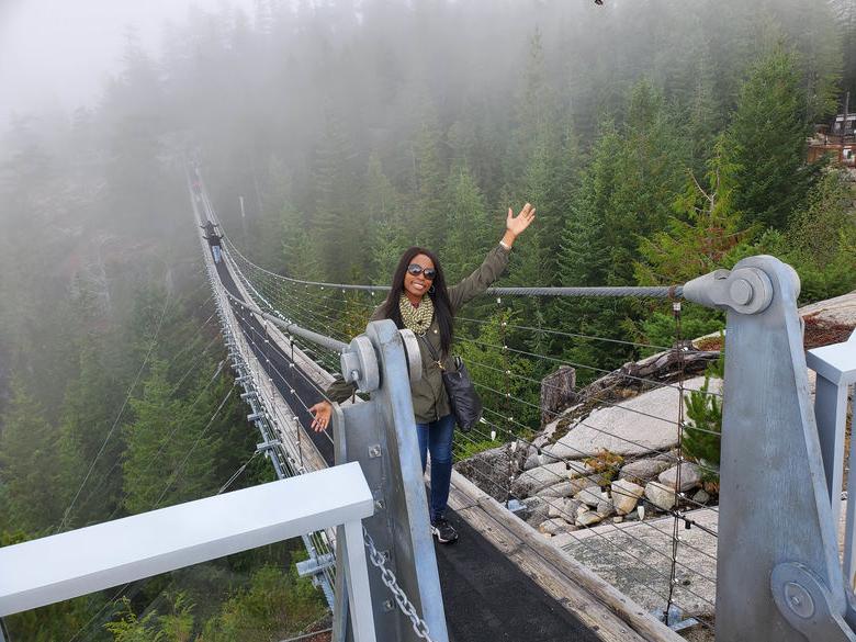 Student standing on a bridge